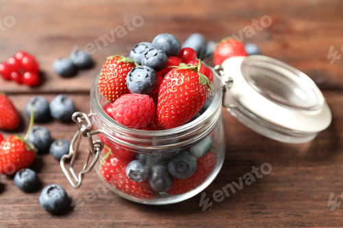Preview: Mix of ripe berries on wooden table, closeup