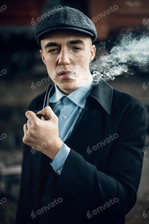 Preview: Stylish gangster smoking in tweed look, posing on background of railway