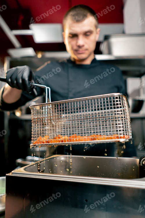 Preview: close-up of cooked sweet potato potatoes just taken out of deep fryer oil dripping