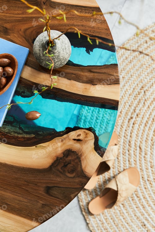 Preview: Close up of epoxy wooden coffee table with glass , nuts and book. Details. Texture.
