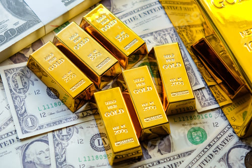 Preview: Gold bars on the background of dollar bills.