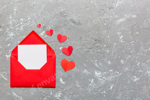 Preview: Red paper envelope with empty white card and heart on colored background. top view