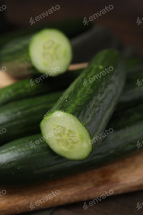Preview: Many fresh cucumbers on wooden table, closeup