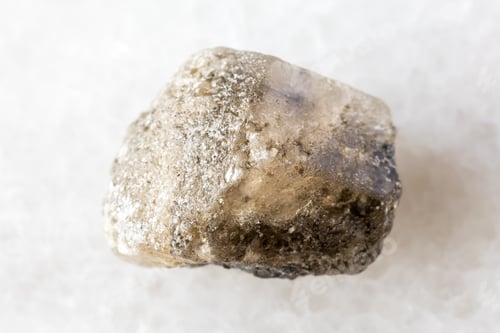 Preview: sample of rough phenakite mineral on white marble