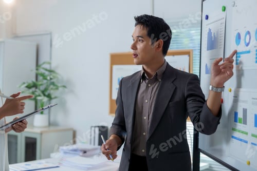 Preview: Asian businessman presenting financial data analysis during a meeting