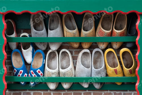 Preview: Typical Dutch image of old used clogs in a wooden rack