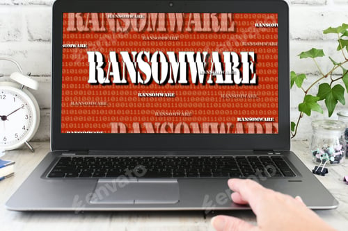 Preview: Person working on a laptop computer that has been seized by a ransomware cyber attack. hacked virus