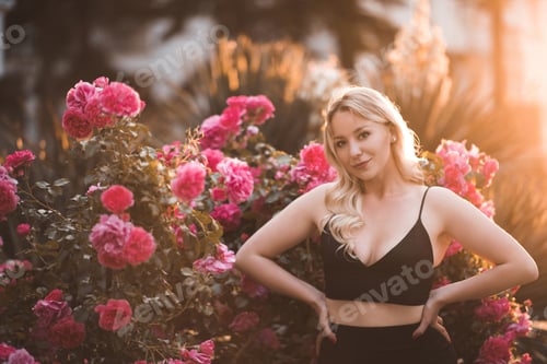 Preview: Smiling woman holding flower roses in meadow closeup. Summer time season.