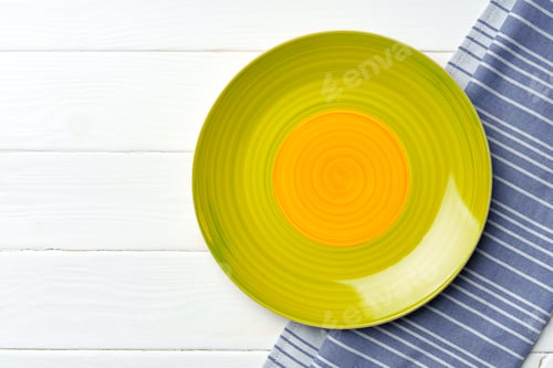 Preview: Top view of color ceramic plate on wooden background