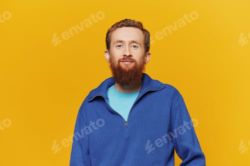 Preview: Portrait of a man smiling in a blue sweater on a yellow background copy space, space for text