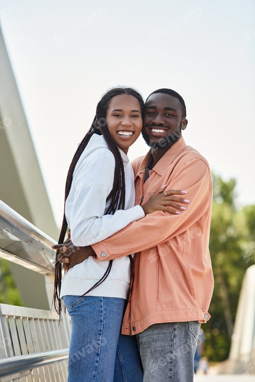 Preview: Young couple shares a joyful moment while walking together in the sunshine on a beautiful day