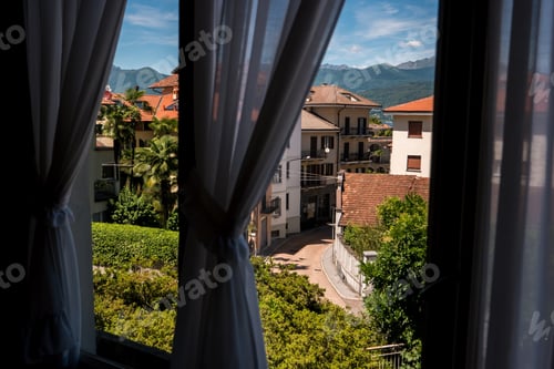 Preview: Nature and town behind window.