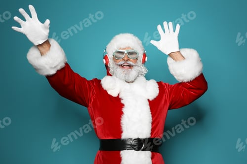 Preview: Santa Claus listening to Christmas music on color background