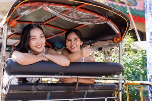 Preview: Young asian women traveling tuk tuk enjoying thailand vacation