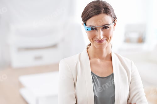 Preview: Instant access. Portrait of a young businesswoman wearing smart glasses at work.