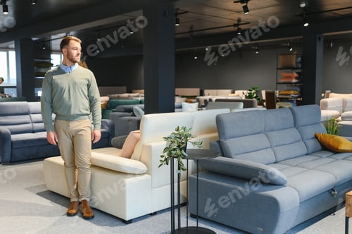 Preview: A handsome young man chooses furniture in a store