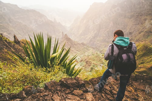 Preview: Santo Antao Island, Cape Verde. Hiking outdoor activity. Male traveler with backpack photographing