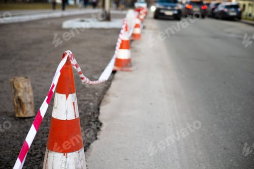 Preview: Under construction board sign on the closed road with arrow sign and traffic cone. Caution symbol un