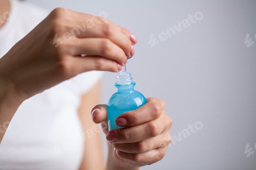 Preview: Beautiful young woman holding moisturizer cream on her hands