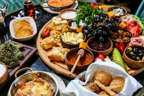 Preview: side view breakfast set olives cheese sausage pancakes vegetables jam honey sour cream butter