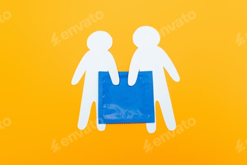 Preview: top view of paper people near blue condom isolated on orange