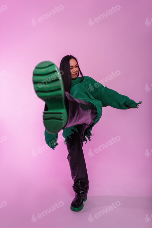 Preview: Beautiful asian fashion girl in stylish knitted ripped green sweater
