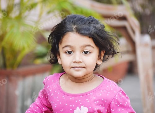 Preview: Closeup shot of a cute South Asian baby girl with beautiful black hair