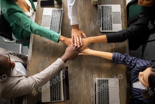 Preview: Top View Of Diverse Coworkers Joining Hands In Office