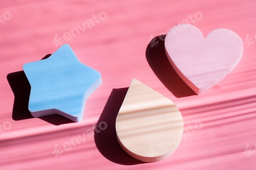Preview: Cosmetic sponges in pastel colors on a pink background with deep shadows. Beauty concept. Copy space