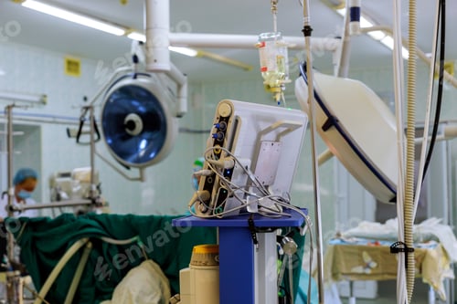 Preview: Surgeons team working of patient in surgery room of modern hospital