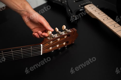 Preview: Guitar tuning process includes adjusting pegs and preparing new strings for better sound