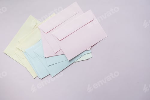 Preview: colorful envelope on pink background with copy space.