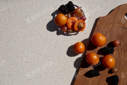 Preview: Fresh healthy summer fruits and berries - apricots, gooseberry and blackberry under hard shadows