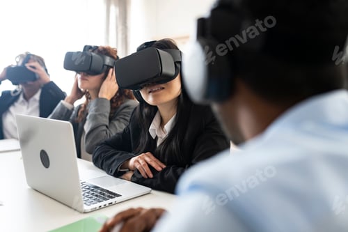 Preview: multi-racial, multi-age coworkers use VR glasses concept, business meeting - focus asian woman -