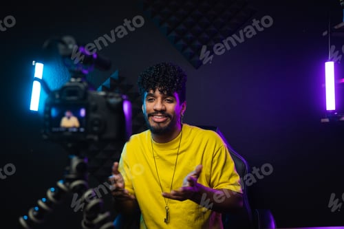 Preview: Cheerful Hispanic man shooting video for vlog