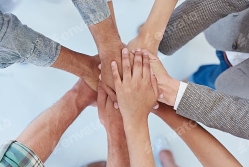 Preview: United in business we stand. Shot of a group of coworkers with their hands in a huddle.