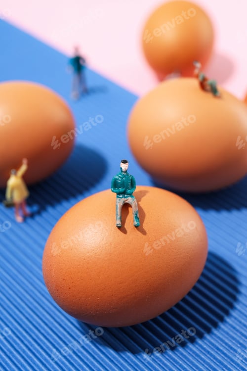 Preview: Miniature people and eggs on two tone background