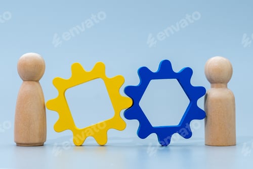 Preview: Two wooden human figures and wooden gear.