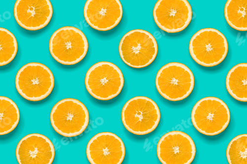Preview: Fruit pattern of orange slices on blue background. Flat lay, top view. Food background.