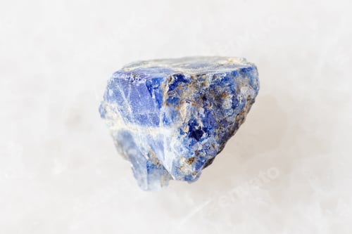 Preview: sample of raw benitoite stone on white marble