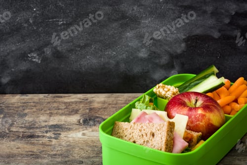 Preview: Healthy lunchbox full of nutritious food for school children on wooden table