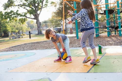 Preview: Children playing basketball in playground