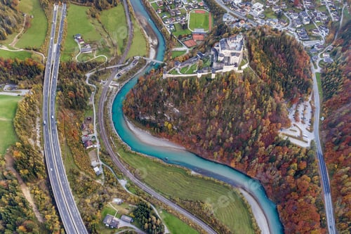 Preview: Aerial view of green meadows with villages and forest in austrian Alps mountains.