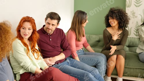 Preview: Group of friends talking sitting together in a sofa