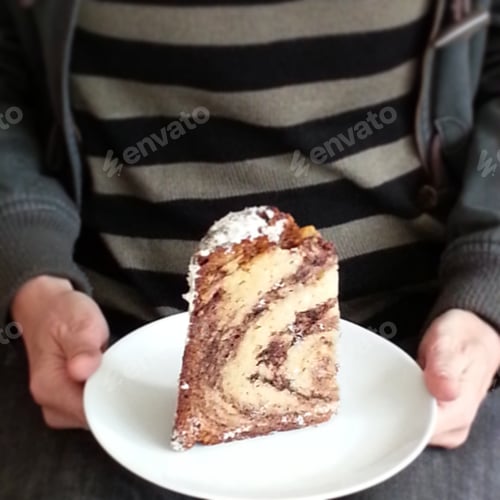 Preview: Hands holding plate with slice of cake