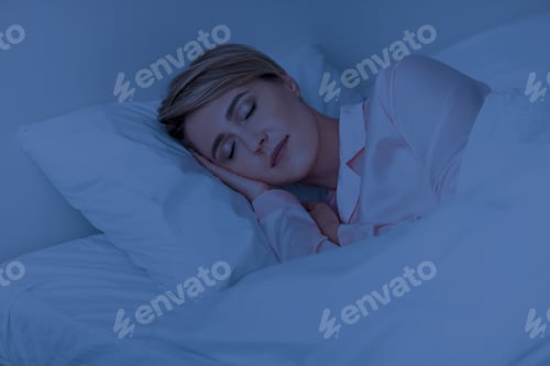 Preview: Beautiful mature woman sleeping well on pillow in the night