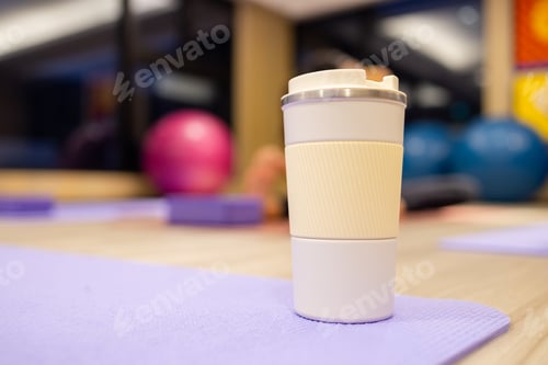 Preview: Woman drink her water bottle in yoga room