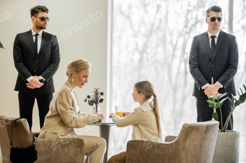 Preview: private security concept, bodyguards standing near female clients, preteen girl and blonde mother