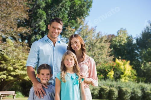 Preview: Cheerful Family Standing In The Countryside Smiling At Camera