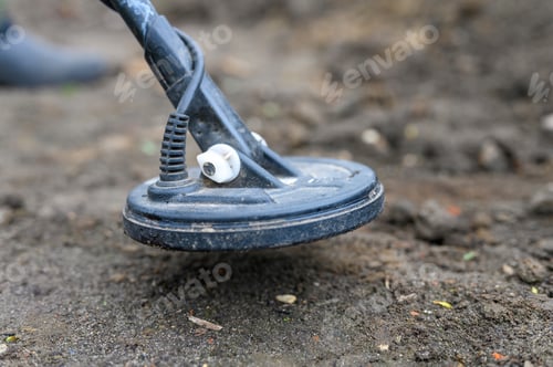 Preview: coil electronic metal detector device for search a treasure on ground background
